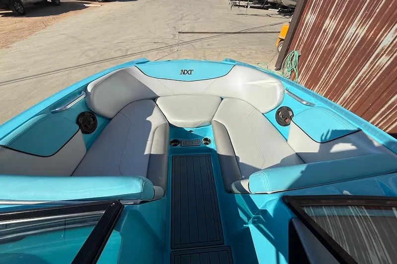 Slide: The Image of 2018 MasterCraft NXT22 boat interior with blue and gray seating. - 11