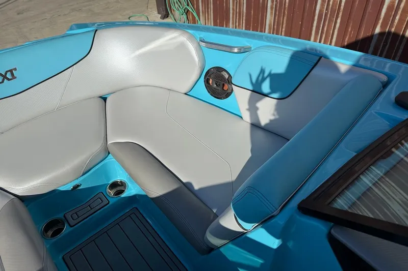 Slide: The Image of 2018 MasterCraft NXT22 boat interior with blue and gray seating. - 13