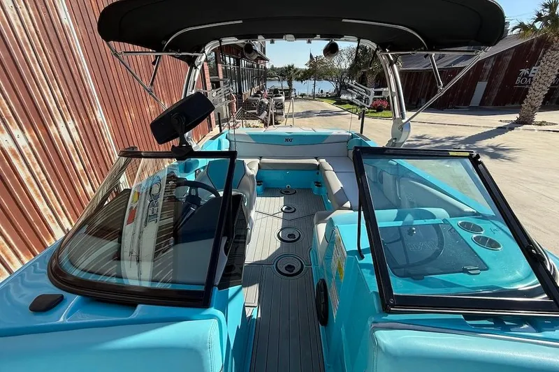 Slide: The Image of 2018 MasterCraft NXT22 boat interior with turquoise seating and black canopy. - 19