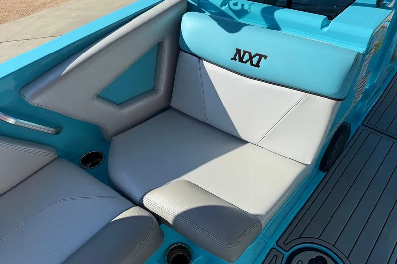 Slide: The Image of 2018 MasterCraft NXT22 boat interior with blue and white seating. - 8