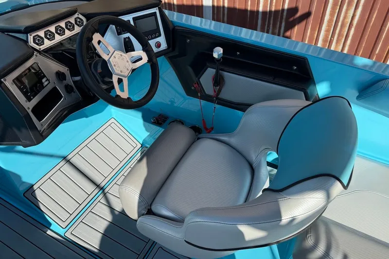 Slide: The Image of 2018 MasterCraft NXT22 boat cockpit with steering wheel and control panel. - 9