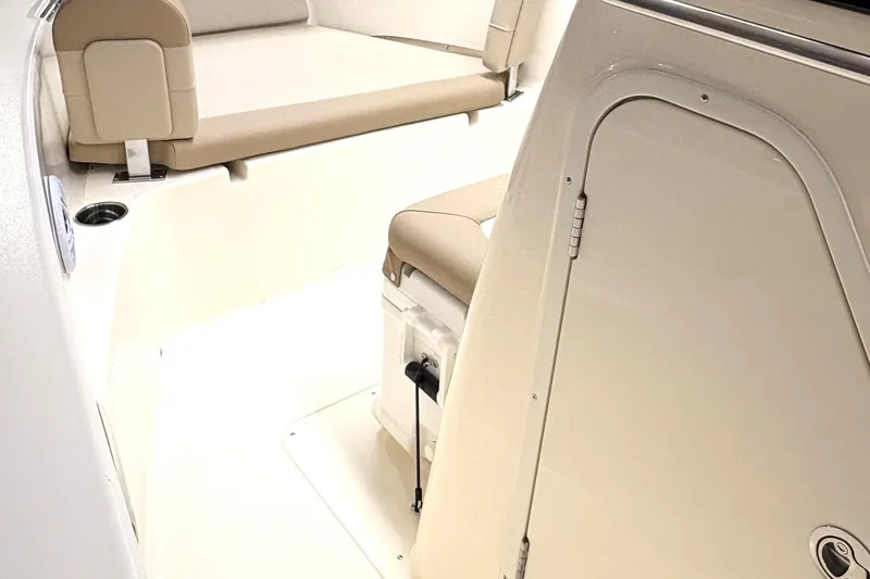Slide: The Image of 2026 Scout 195 Sportfish interior with beige seating and storage compartment. - 14