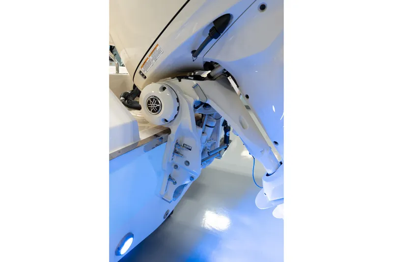 Slide: The Image of 2025 Grady-White 251 Coastal Explorer boat engine detail with blue lighting. - 10