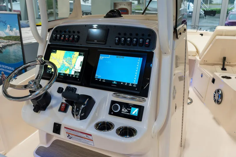 Slide: The Image of 2025 Grady-White 251 Coastal Explorer boat dashboard with advanced navigation displays. - 13