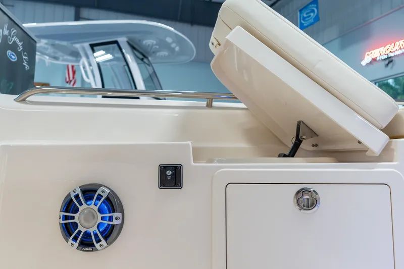 Slide: The Image of 2025 Grady-White 251 Coastal Explorer boat interior with speaker and storage compartment. - 16