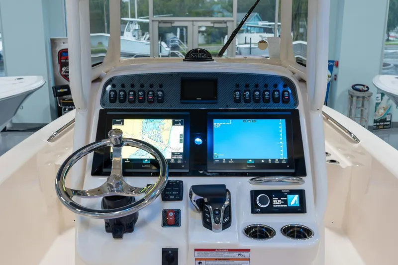 Slide: The Image of 2025 Grady-White 251 Coastal Explorer boat dashboard with advanced navigation displays. - 17