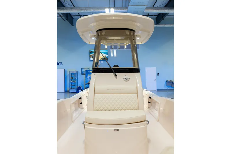 Slide: The Image of 2025 Grady-White 251 Coastal Explorer boat interior with cushioned seating and helm. - 18