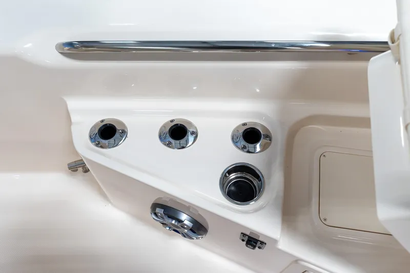 Slide: The Image of 2025 Grady-White 251 Coastal Explorer boat interior with cup holders and chrome accents. - 19