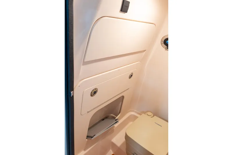 Slide: The Image of 2025 Grady-White 251 Coastal Explorer interior cabin with compact toilet. - 23