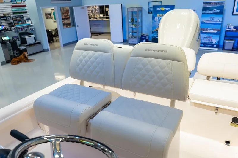 Slide: The Image of 2025 Grady-White 251 Coastal Explorer boat interior with luxurious seating in showroom. - 25