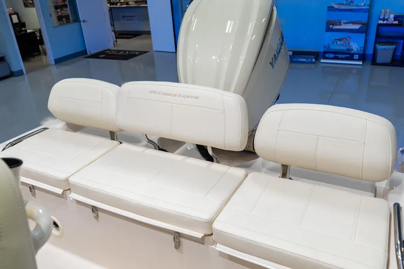 Slide: The Image of 2025 Grady-White 251 Coastal Explorer boat seats in showroom, featuring white upholstery. - 26