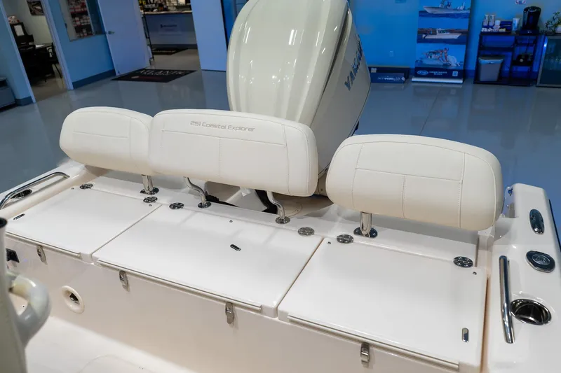 Slide: The Image of 2025 Grady-White 251 Coastal Explorer boat interior with white seating and engine view. - 30