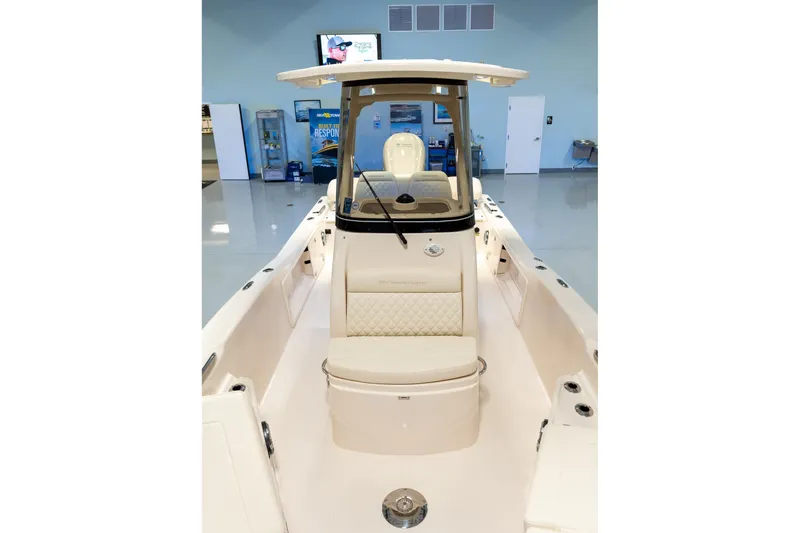 Slide: The Image of 2025 Grady-White 251 Coastal Explorer boat interior with seating and console. - 32