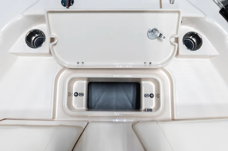 Slide: The Image of 2025 Grady-White 251 Coastal Explorer boat storage compartment with cup holders. - 33