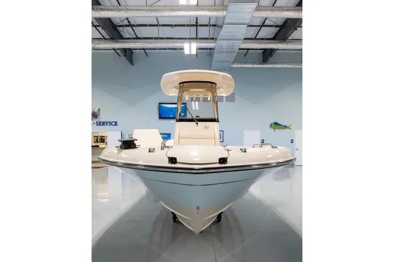 Slide: The Image of 2025 Grady-White 251 Coastal Explorer boat displayed in a showroom. - 5