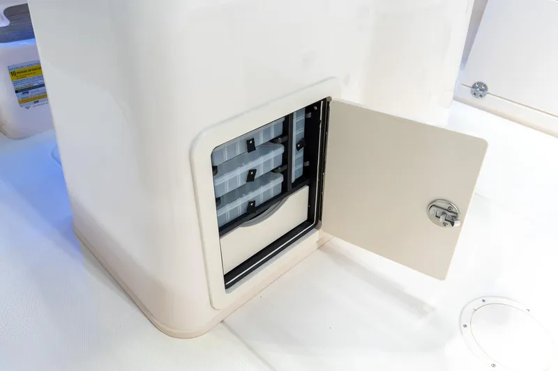 Slide: The Image of 2025 Grady-White 251 Coastal Explorer storage compartment with open door, showcasing interior organization. - 8