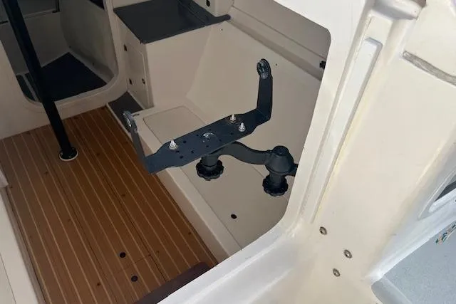 Slide: The Image of Interior view of a 2017 J Boats J/88 sailboat, featuring a wooden floor and mounting bracket. - 11