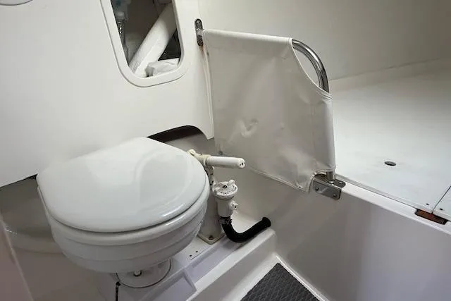 Slide: The Image of 2017 J Boats J/88 interior with compact marine toilet and privacy curtain. - 14