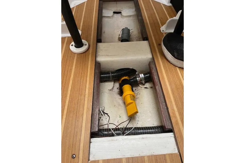 Slide: The Image of 2017 J Boats J/88 interior bilge with pump and wooden flooring. - 19