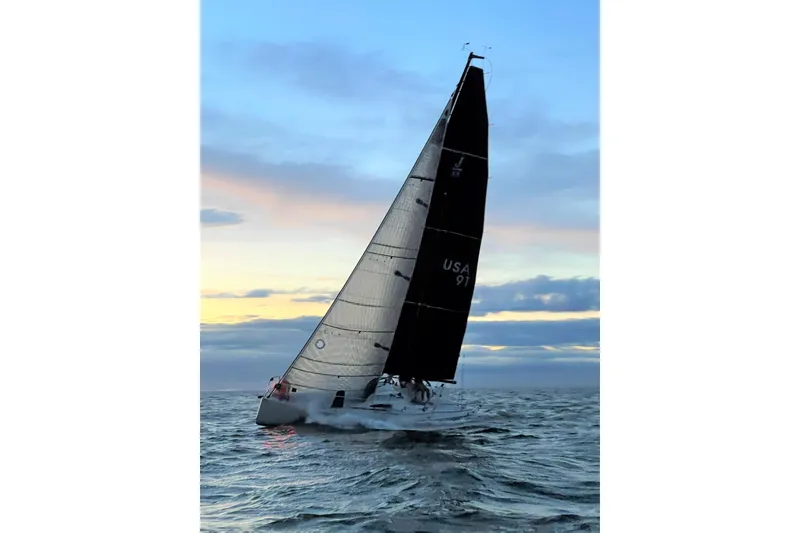 Slide: The Image of 2017 J Boats J/88 sailing at sunset on open water. - 2