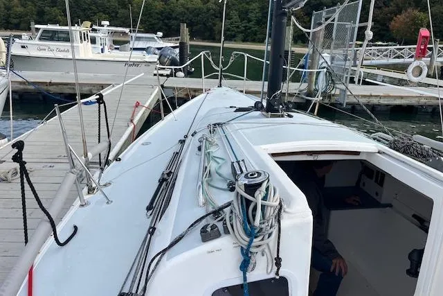 Slide: The Image of 2017 J Boats J/88 sailboat docked at a marina, showing deck and cabin entrance. - 21
