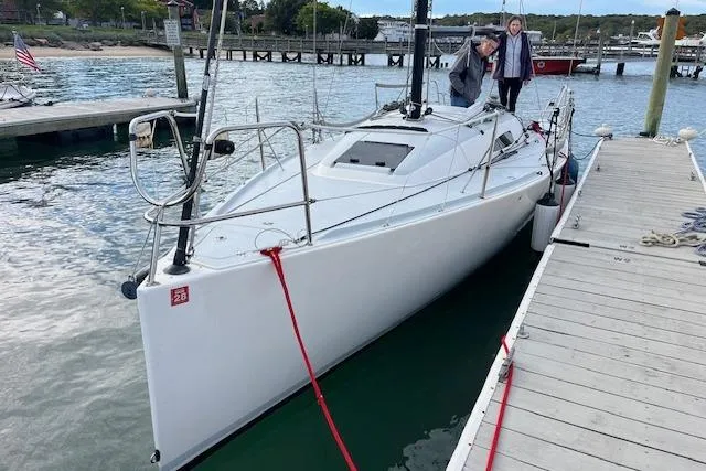 Slide: The Image of 2017 J Boats J/88 docked, with two people on deck, in a marina setting. - 26