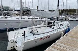 Slide: The Image of 2017 J Boats J/88 sailboat named "Red Sky" docked at a marina. - 30