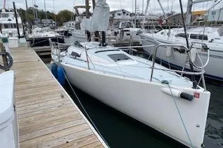 Slide: The Image of 2017 J Boats J/88 sailboat docked at a marina, surrounded by other vessels. - 31