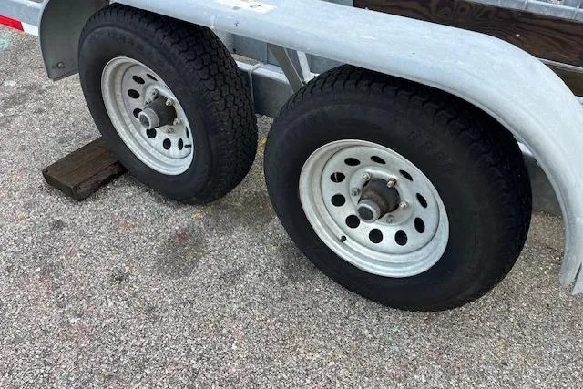 Slide: The Image of Trailer wheels for 2017 J Boats J/88 sailboat on pavement. - 36