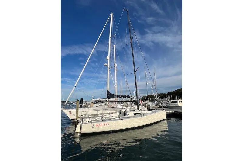 Slide: The Image of 2017 J Boats J/88 sailboat "Red Sky" docked at marina under clear blue sky. - 7