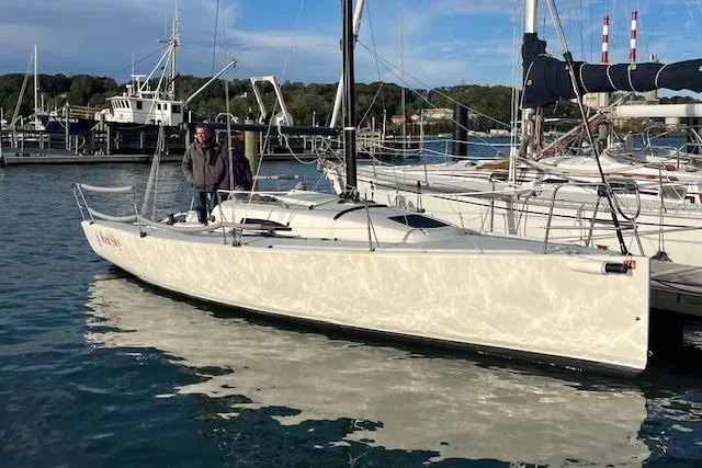 Slide: The Image of 2017 J Boats J/88 sailboat docked in a marina with two people on board. - 9