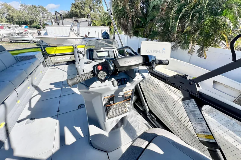 Slide: The Image of 2023 Sea-Doo Switch Cruise 21 interior with steering console and Garmin navigation system. - 16