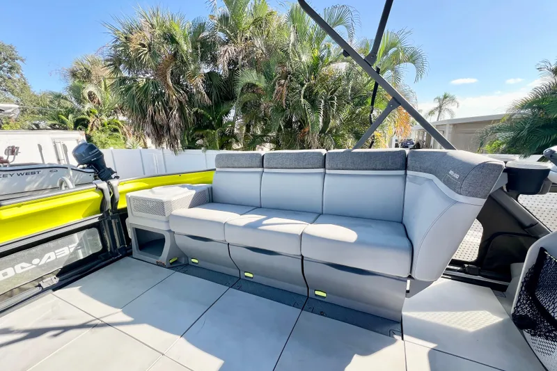 Slide: The Image of 2023 Sea-Doo Switch Cruise 21 interior with comfortable seating and tropical background. - 19
