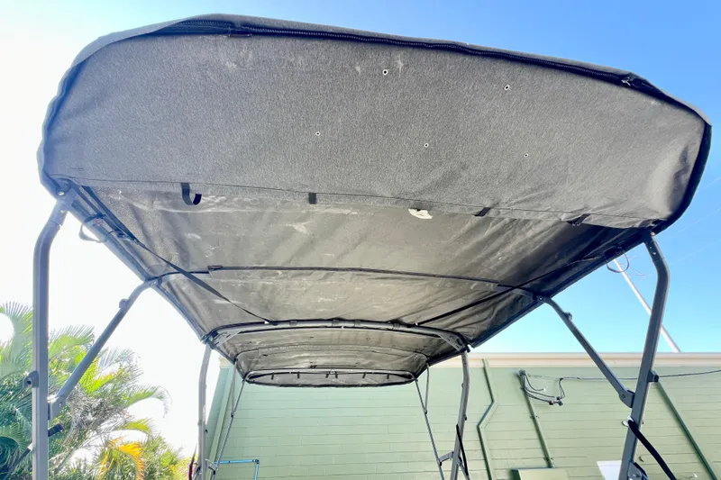 Slide: The Image of 2023 Sea-Doo Switch Cruise 21 canopy viewed from below, showcasing sturdy frame and fabric. - 24