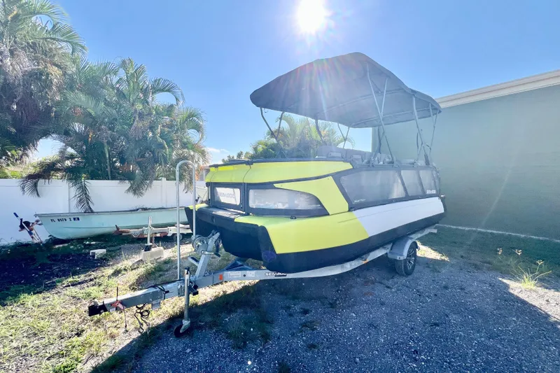 Slide: The Image of 2023 Sea-Doo Switch Cruise 21 on trailer, parked outdoors under sunny sky. - 4