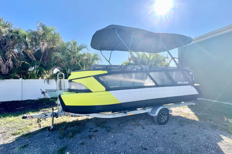 Slide: The Image of 2023 Sea-Doo Switch Cruise 21 boat on trailer under sunny sky. - 5