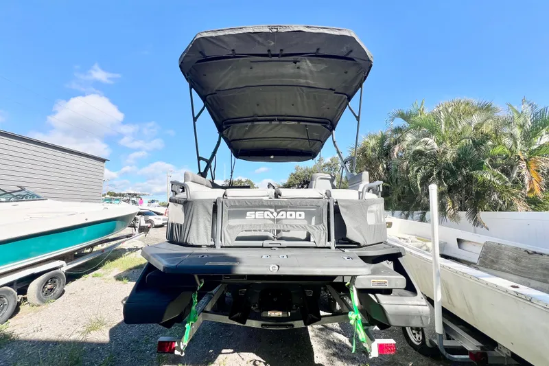 Slide: The Image of 2023 Sea-Doo Switch Cruise 21 pontoon boat with canopy, parked outdoors. - 7