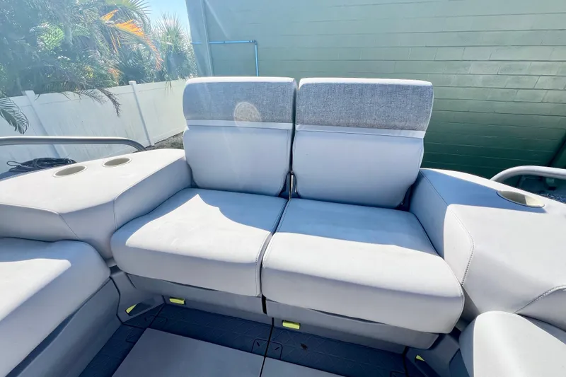 Slide: The Image of 2023 Sea-Doo Switch Cruise 21 interior seating with cup holders, showcasing comfort and style. - 9