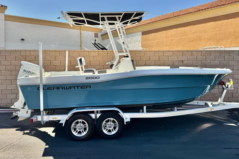 The Image of 2021 Clearwater 2000 C/C boat on trailer, parked outdoors, side view. - 0