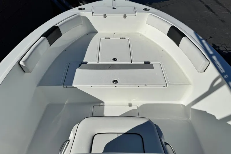 Slide: The Image of 2021 Clearwater 2000 C/C boat interior with white seating and storage compartments. - 12