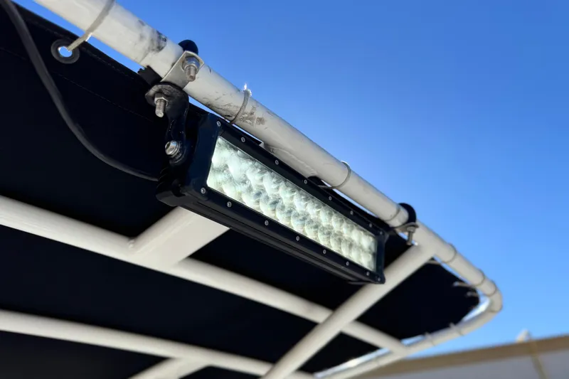Slide: The Image of LED light bar mounted on a 2021 Clearwater 2000 C/C boat frame under clear blue sky. - 17