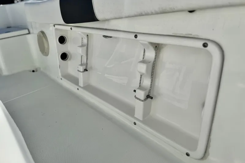 Slide: The Image of Clearwater 2000 C/C 2021 boat interior detail with storage compartment and cup holders. - 20