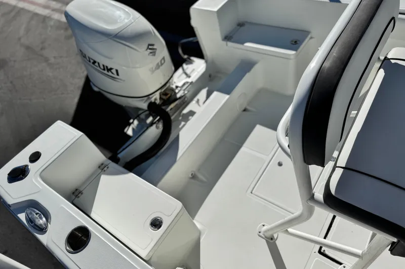 Slide: The Image of Clearwater 2000 C/C 2021 boat interior with Suzuki engine, featuring seating and storage compartments. - 22