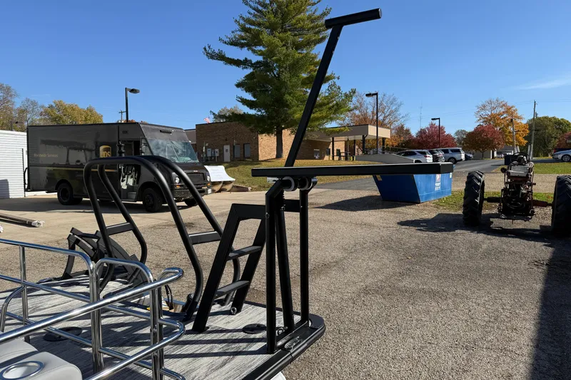 Slide: The Image of 2026 Bentley Pontoons Legacy 243 Swingback in a parking lot with delivery truck and tractor. - 11