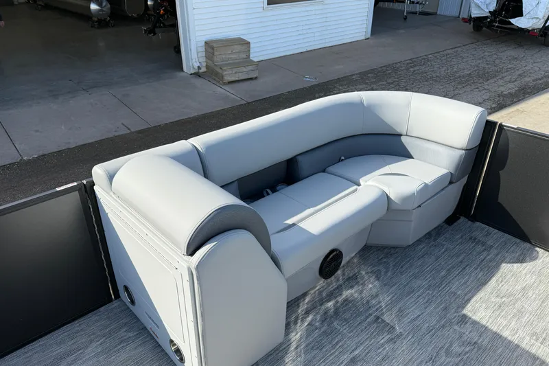 Slide: The Image of 2026 Bentley Pontoons Legacy 243 Swingback with luxurious seating in a marina setting. - 17