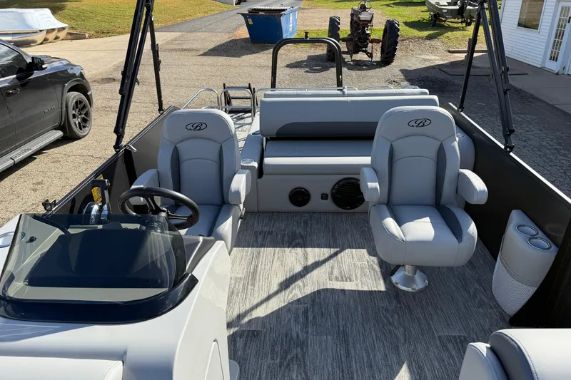 Slide: The Image of 2026 Bentley Pontoons Legacy 243 Swingback interior with gray seating and modern design. - 23