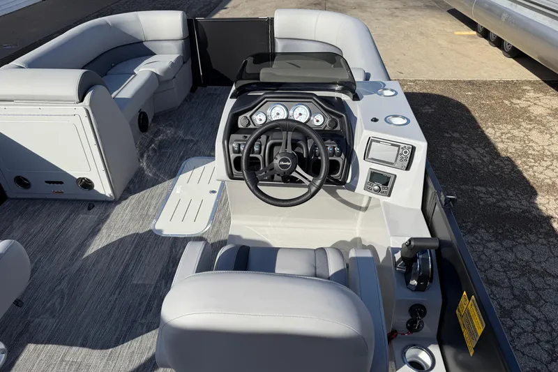 Slide: The Image of 2026 Bentley Pontoons Legacy 243 Swingback interior with modern dashboard and seating. - 24
