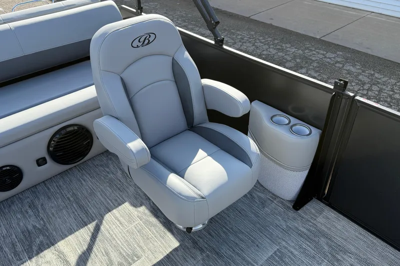 Slide: The Image of 2026 Bentley Pontoons Legacy 243 Swingback interior with gray captain's chair and cup holders. - 27