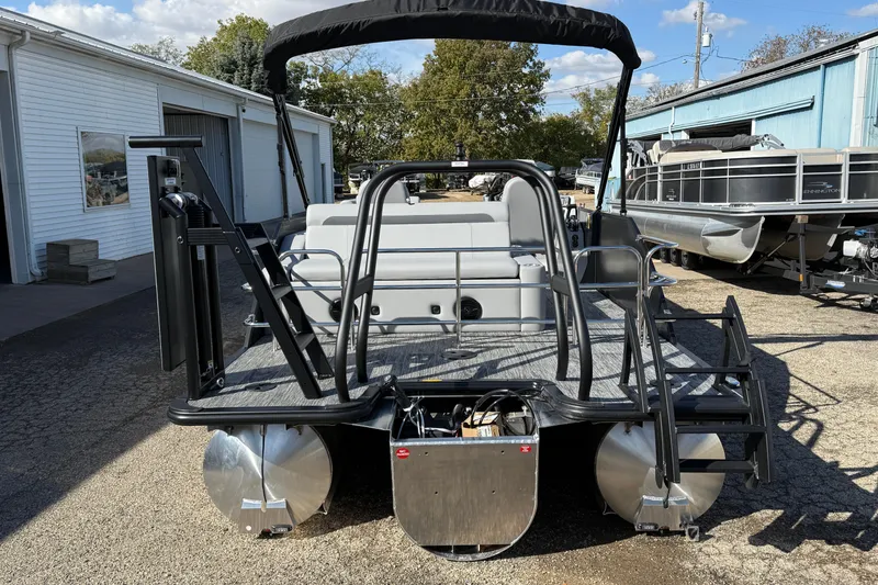 Slide: The Image of 2026 Bentley Pontoons Legacy 243 Swingback, rear view at a marina, showcasing sleek design. - 3