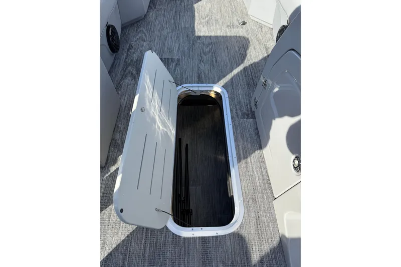 Slide: The Image of Open storage compartment on 2026 Bentley Pontoons Legacy 243 Swingback boat. - 31